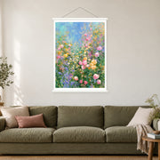 Pastel Flowers in Blue Air, shown as a complete bordered art print with white hanging rods above a sofa in a living room.